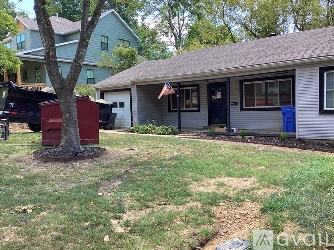 A house with a tree in front of it.