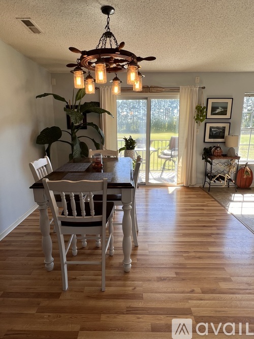 A dining room with a wooden table and chairs.
