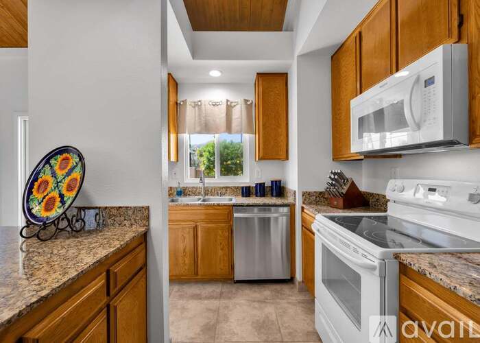A kitchen with wooden cabinets and a white oven.