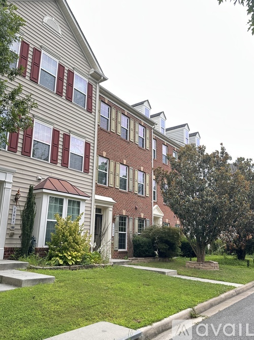 A two-story house with a red brick exterior and white trim.