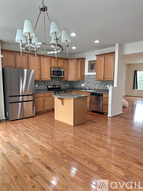 A kitchen with wooden floors and a large island.