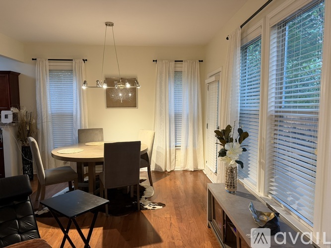 A dining room with a table and chairs.