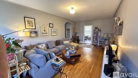 A living room with a grey couch and a coffee table.