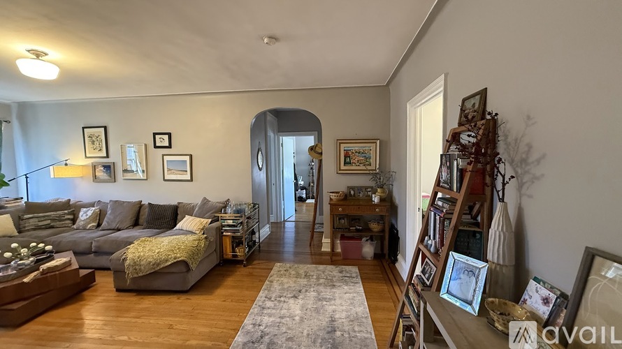 A living room with a grey couch and a wooden coffee table.