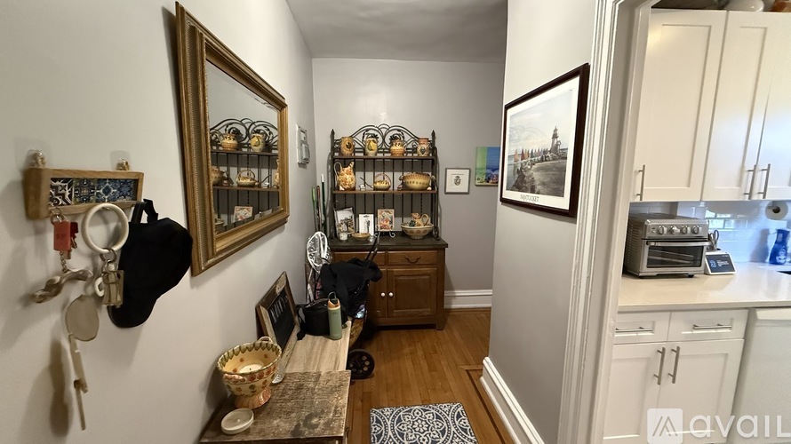 A kitchen with a white fridge and a wooden table with a basket on it.