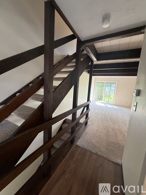 A wooden staircase with a carpeted floor.