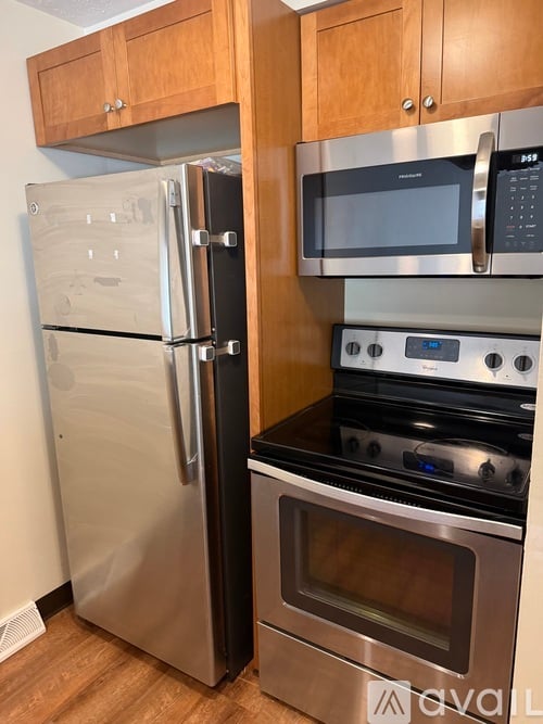 A kitchen with a stainless steel refrigerator and oven.
