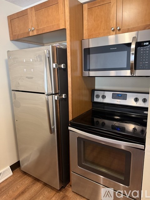 A kitchen with a stainless steel refrigerator and oven.