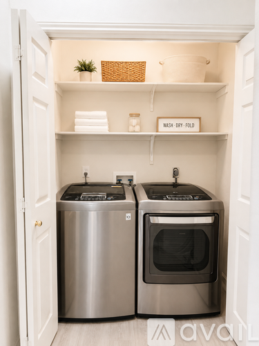 A small laundry room with a washer and dryer.