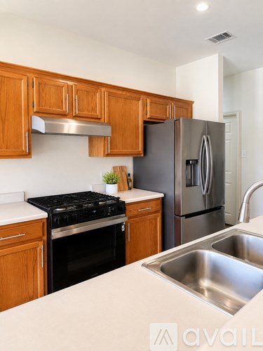 A kitchen with wooden cabinets and stainless steel appliances.