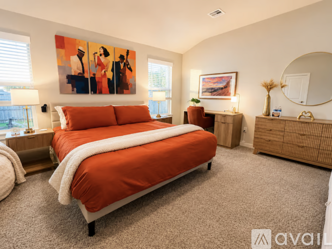 A bedroom with a large bed and a painting on the wall.