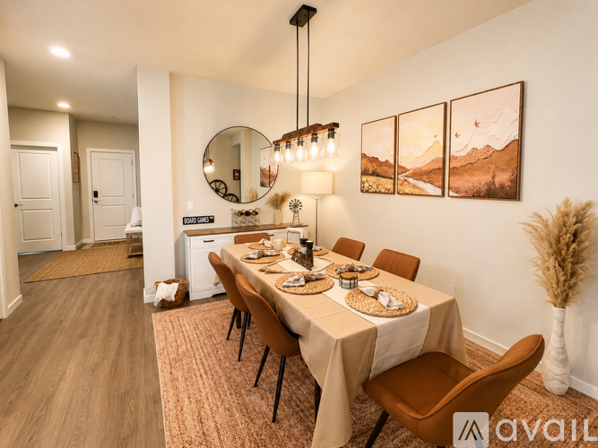 A dining room with a table set for a meal.
