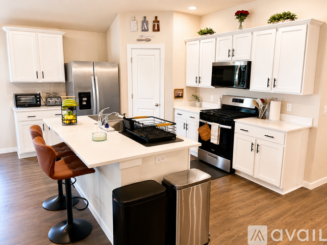 A kitchen with white cabinets and a black stove top oven.