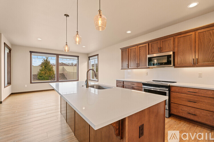 A kitchen with wooden cabinets and a white countertop.