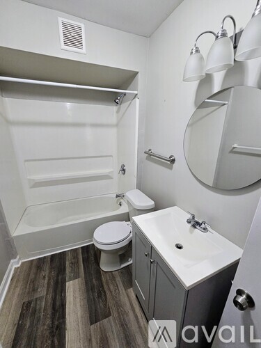 A bathroom with a toilet, sink, and shower.