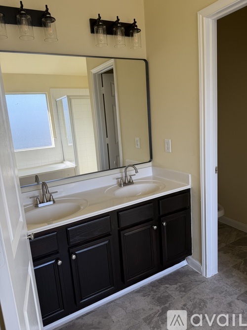 A bathroom with a sink and a mirror.