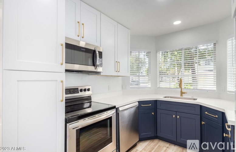 A kitchen with white cabinets and a black stove top oven.