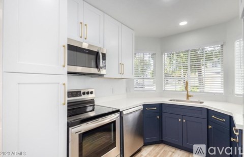 A kitchen with white cabinets and a black stove top oven.