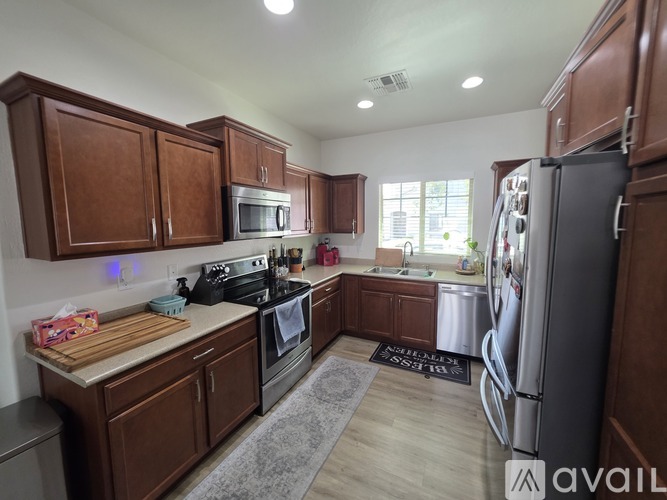 A kitchen with wooden cabinets and stainless steel appliances.