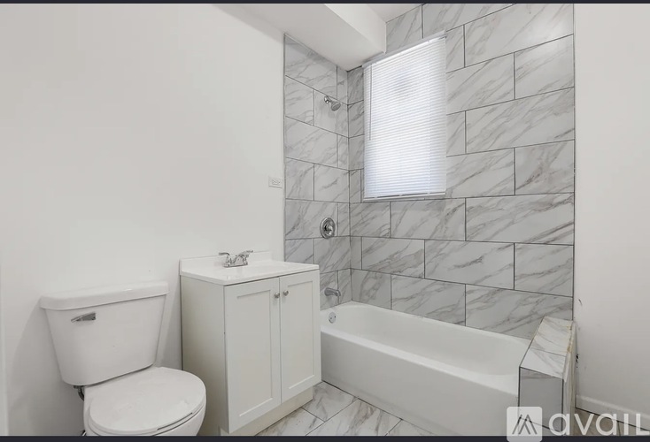 A bathroom with a toilet, sink, and bathtub.