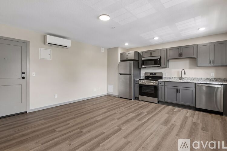 A kitchen with wooden floors and stainless steel appliances.