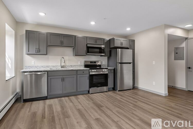 A kitchen with wooden floors and stainless steel appliances.