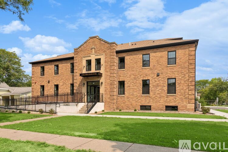 A brick building with a black gate in front.