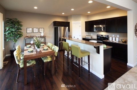 A kitchen with a dining table set for four.
