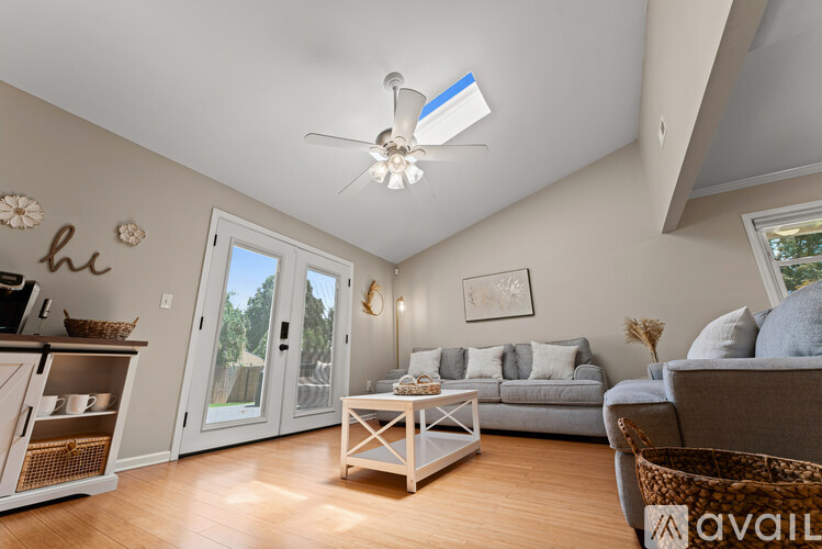 A living room with a grey couch and a white coffee table.