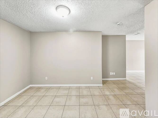 A room with wooden floors and a white door.