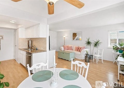 A living room with a white table and chairs.