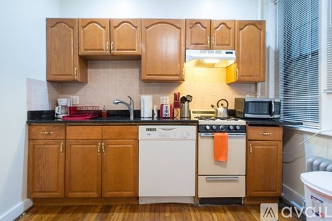 A kitchen with wooden cabinets and appliances.