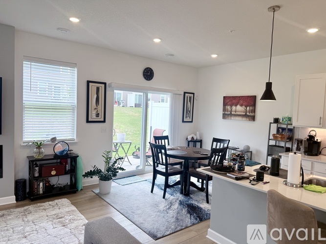A kitchen with a table and chairs in front of a window.