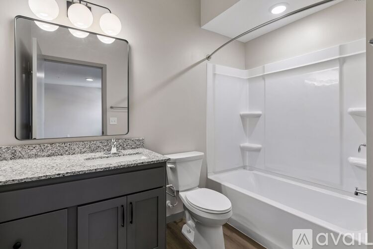A bathroom with a toilet, sink, and bathtub.