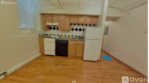 A kitchen with wooden cabinets and a white fridge.