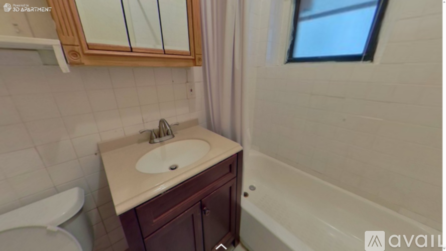 A bathroom with a sink, mirror, and bathtub.