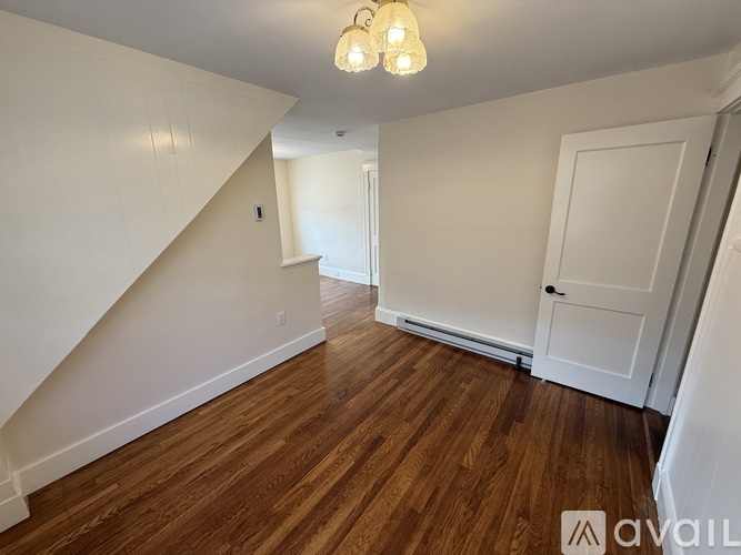 A room with wooden floors and a white door.
