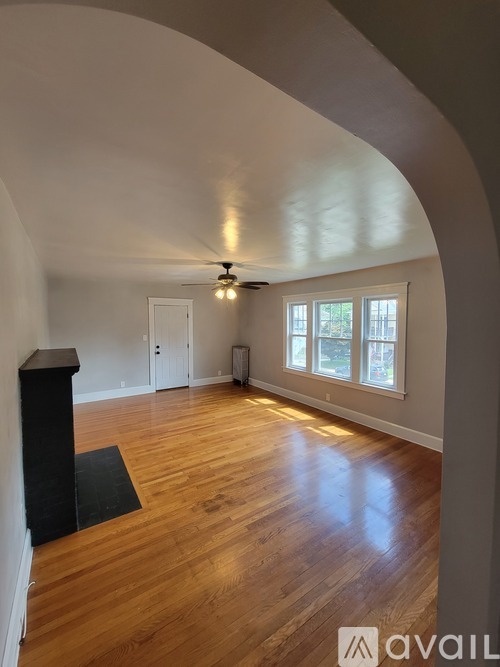 A room with wooden floors and a ceiling fan.