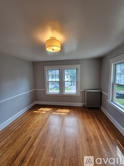 A room with wooden floors and a window.