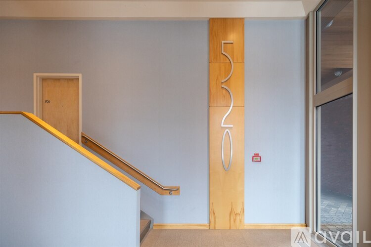A wooden staircase with a number 530 on the wall.