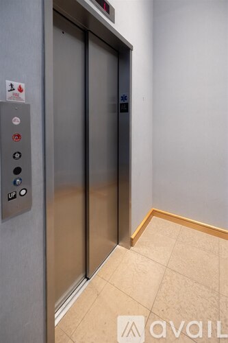 An elevator with a button labeled 'Lift' is in the corner of a room.