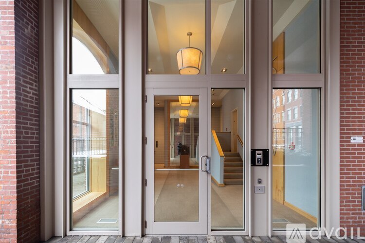 A set of double doors with glass panels and a chandelier hanging from the ceiling.