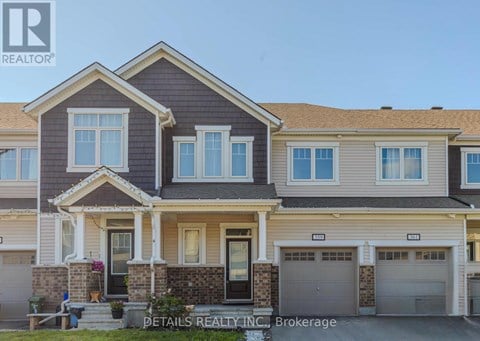 A house with a grey roof and a white garage door.