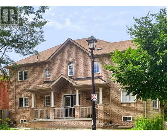 A red brick house with a black lamp post and a no parking sign.