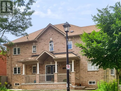 A red brick house with a black lamp post and a no parking sign.