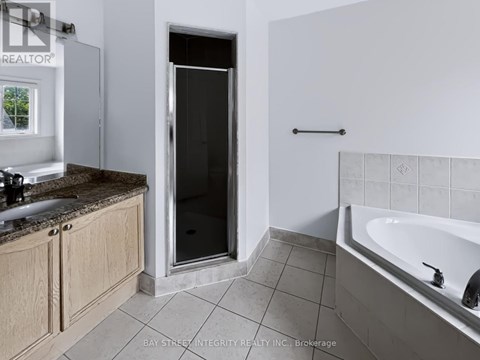 A bathroom with a tub, sink, and shower.