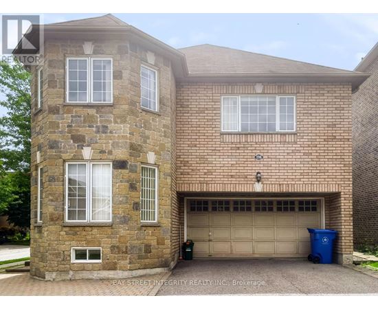 A brick house with a garage door and a window.