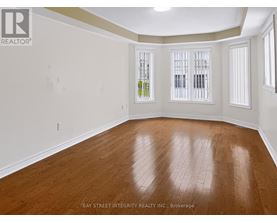 A room with wooden flooring and white walls.