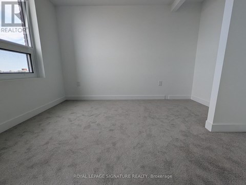 A room with carpeted floor and a window.