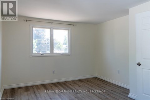 A room with a window and a door.